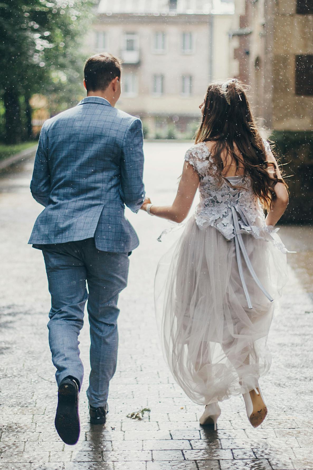 Couple runs through the rain after their wedding