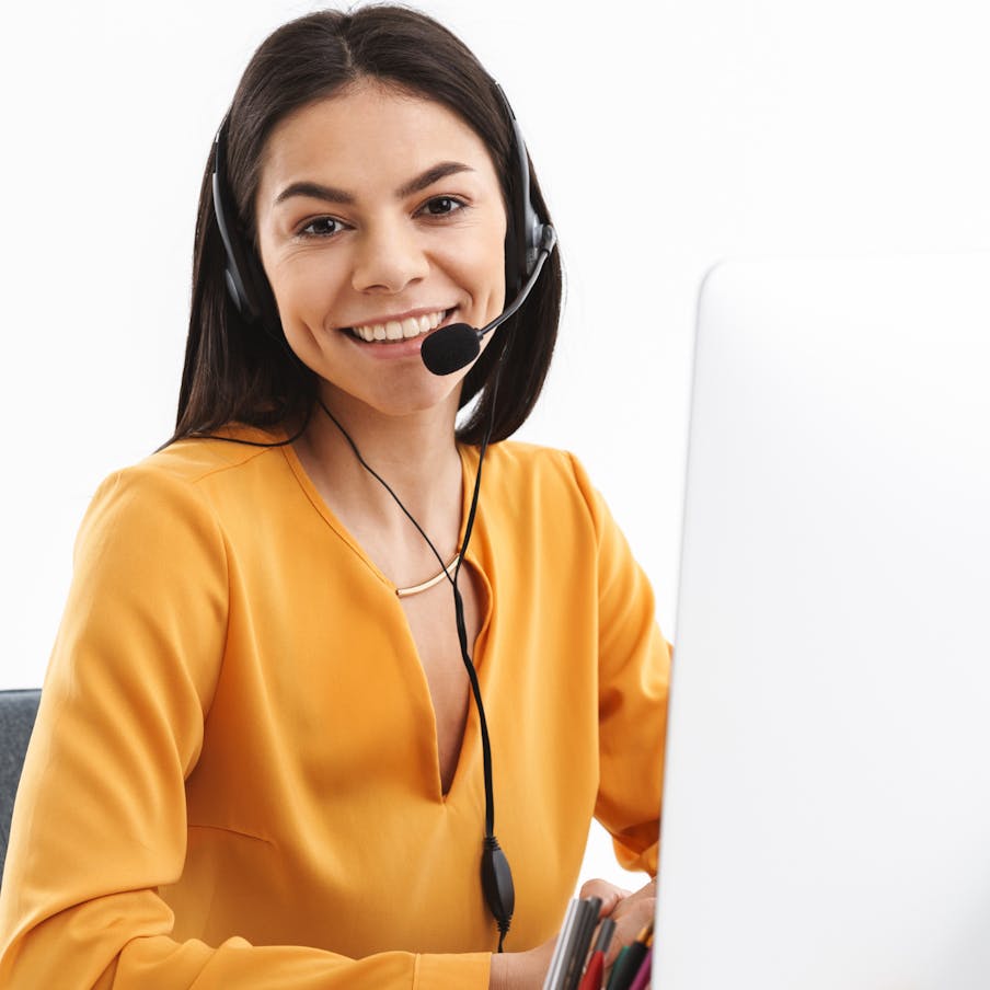 Contact support woman with headset in call center.