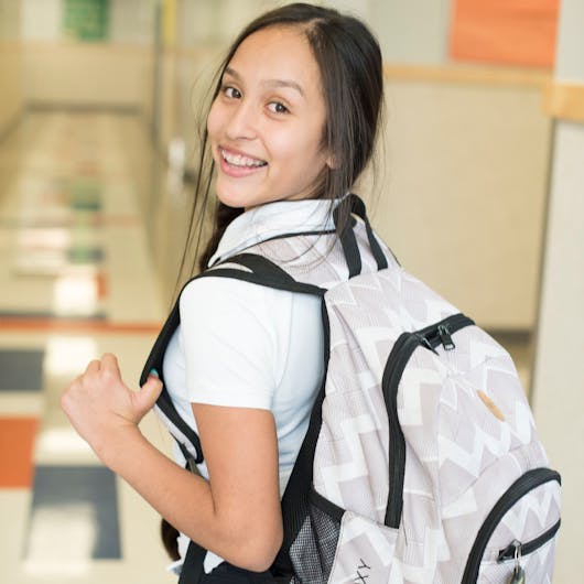  Female student smiling with backpack on. 