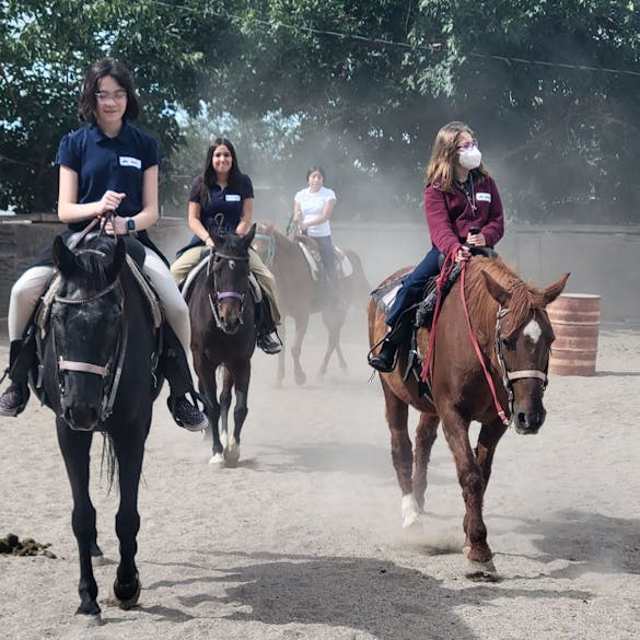  Four students horseback riding 
